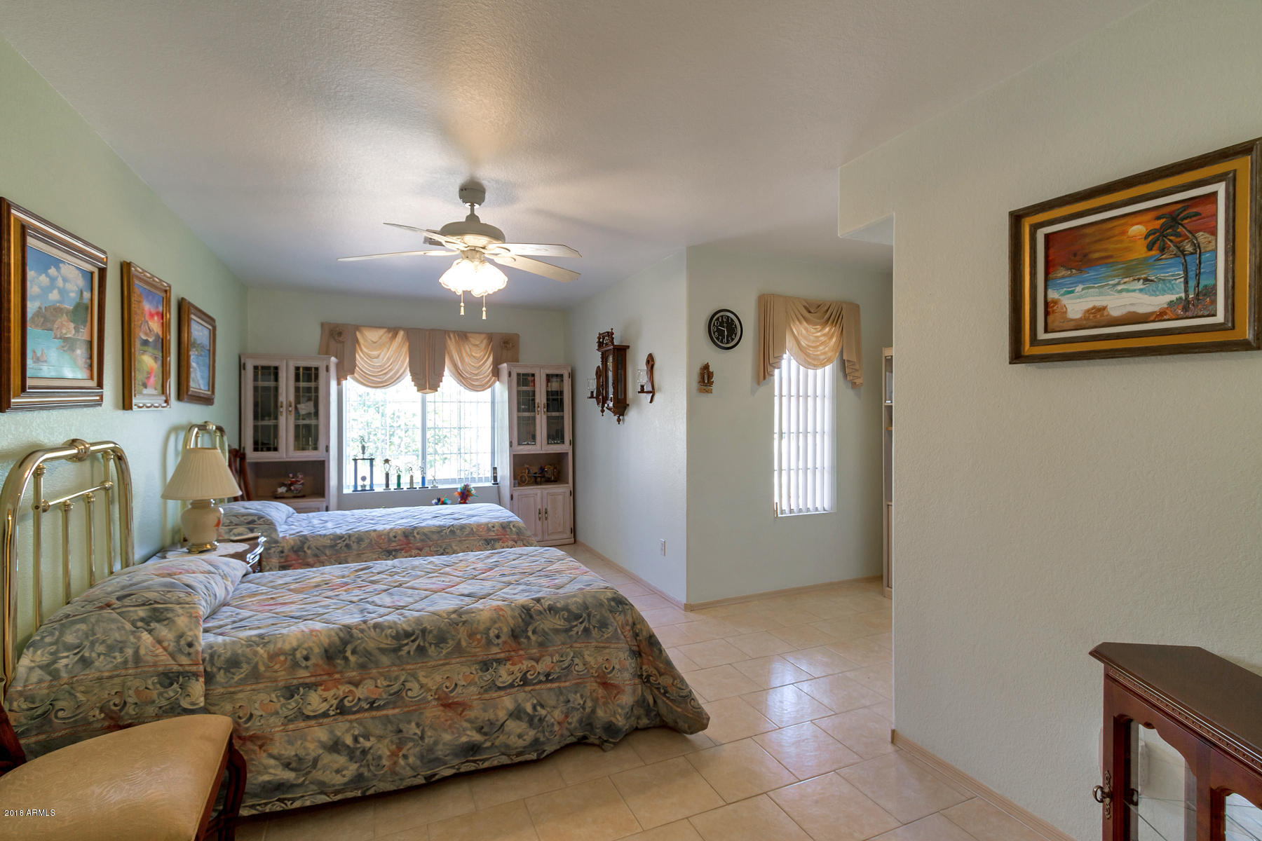 3941 West Charter Oak Road Phoenix, AZ 85029 - Photo 18 of 25 a spacious bedroom with a bed and dresser