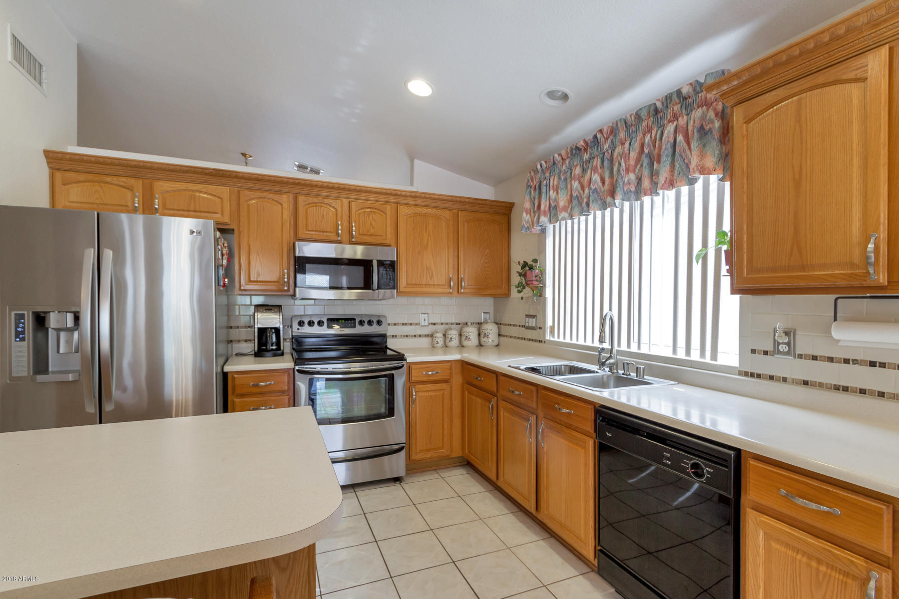 3941 West Charter Oak Road Phoenix, AZ 85029 - Photo 2 of 25 a kitchen with stainless steel appliances granite countertop a refrigerator sink and stove