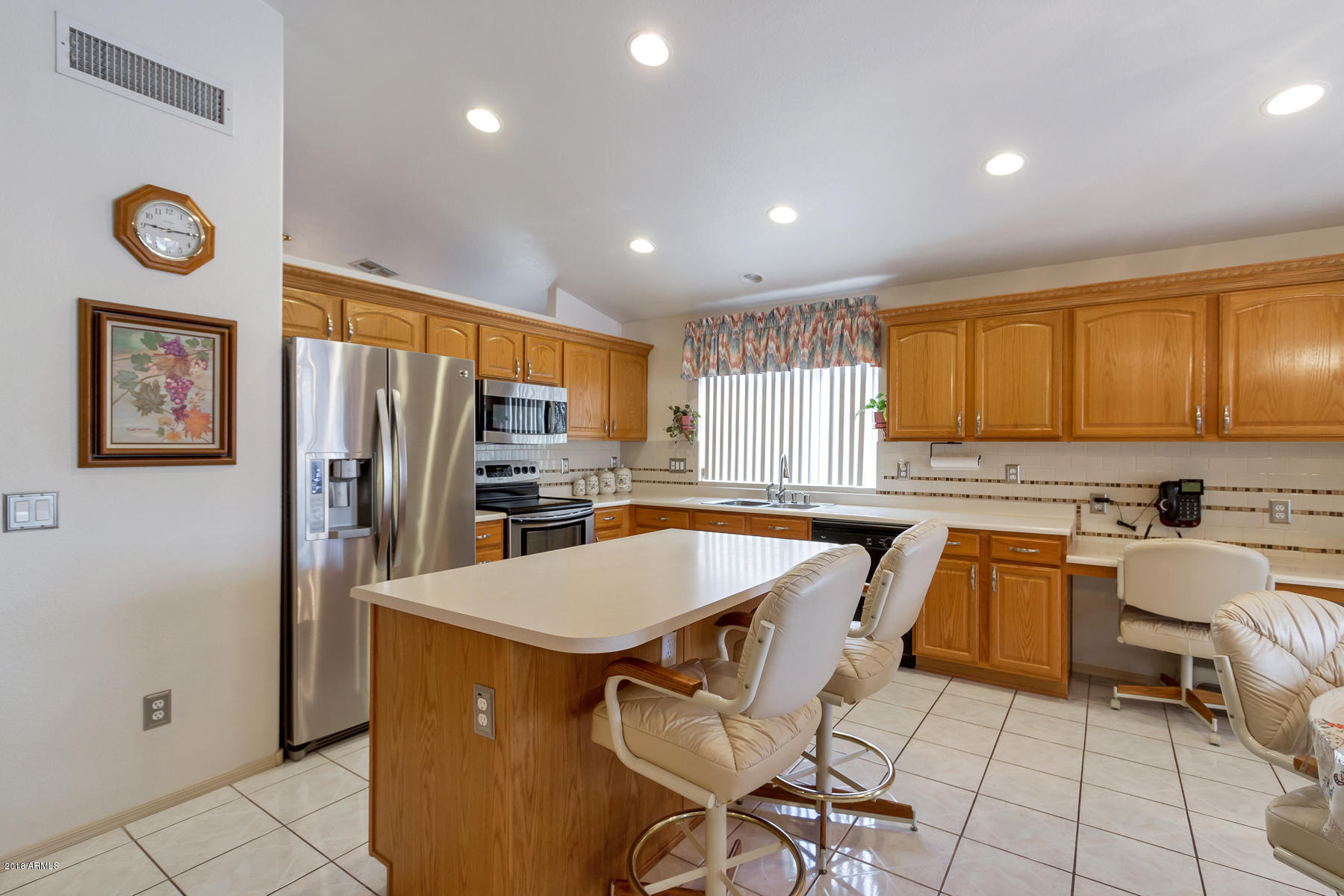 3941 West Charter Oak Road Phoenix, AZ 85029 - Photo 3 of 25 a kitchen with sink cabinets and refrigerator