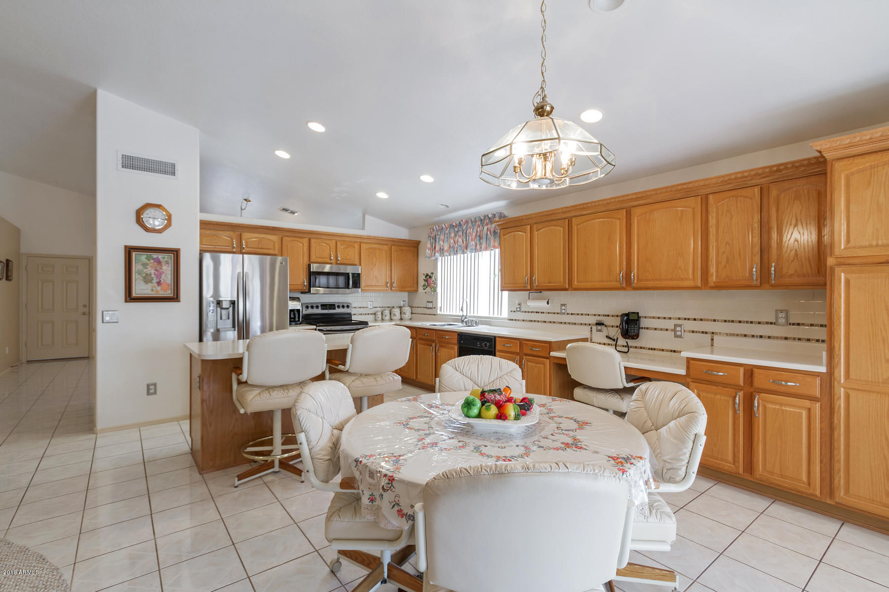 3941 West Charter Oak Road Phoenix, AZ 85029 - Photo 4 of 25 a kitchen with stainless steel appliances granite countertop a sink and a refrigerator