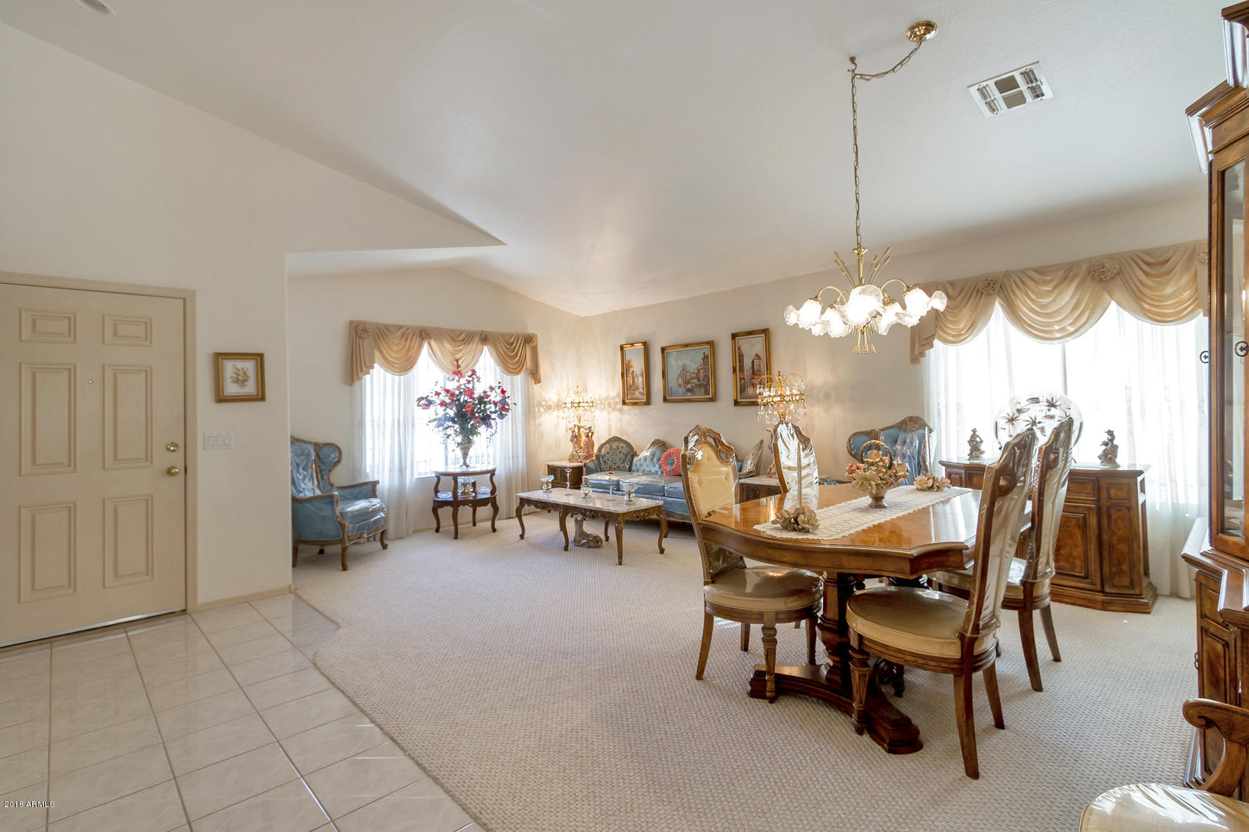 3941 West Charter Oak Road Phoenix, AZ 85029 - Photo 6 of 25 a view of a dining room and livingroom with furniture window and wooden floor