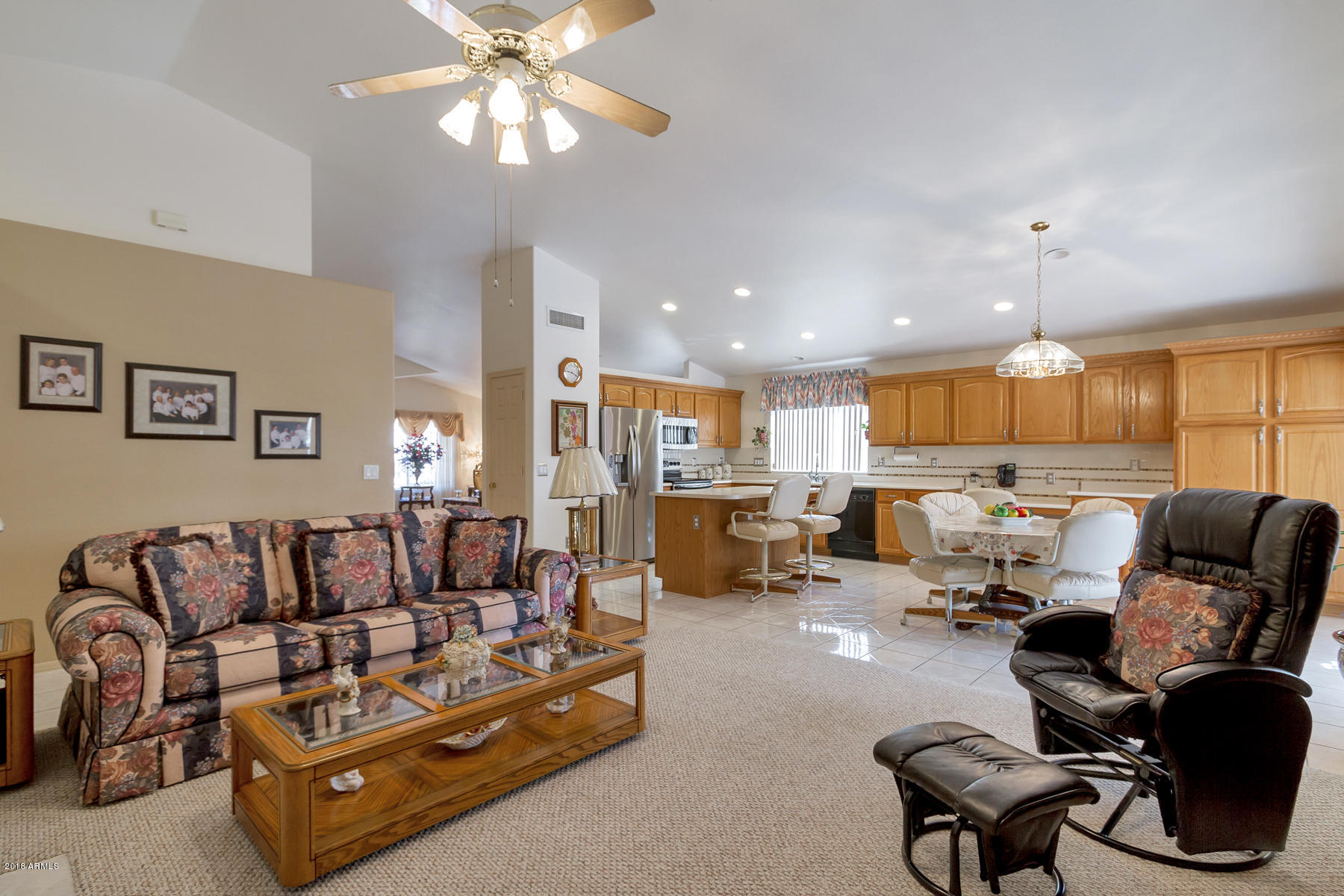 3941 West Charter Oak Road Phoenix, AZ 85029 - Photo 9 of 25 a living room with furniture kitchen view and a chandelier