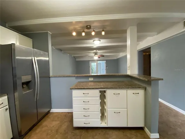 a kitchen with a stove refrigerator and cabinets
