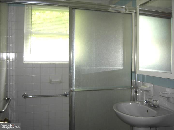 628 Mill Road Trevose, PA 19053 - Photo 13 of 18 a bathroom with a sink and a mirror