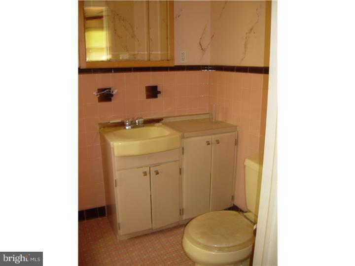 628 Mill Road Trevose, PA 19053 - Photo 16 of 18 a bathroom with a sink a toilet and mirror