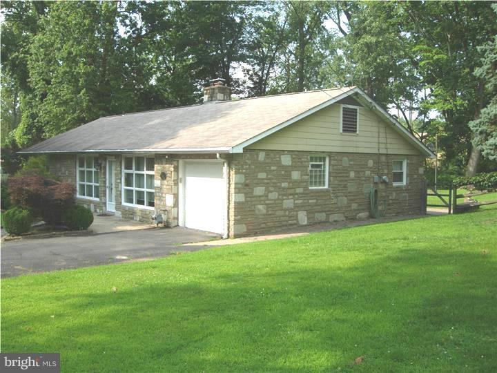 628 Mill Road Trevose, PA 19053 - Photo 3 of 18 a view of a yard in front of a house with large tree