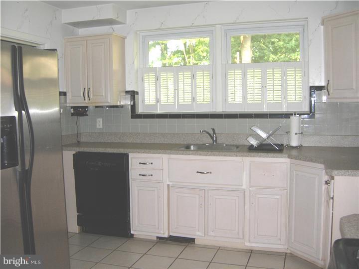 628 Mill Road Trevose, PA 19053 - Photo 9 of 18 a kitchen with granite countertop white cabinets and a sink