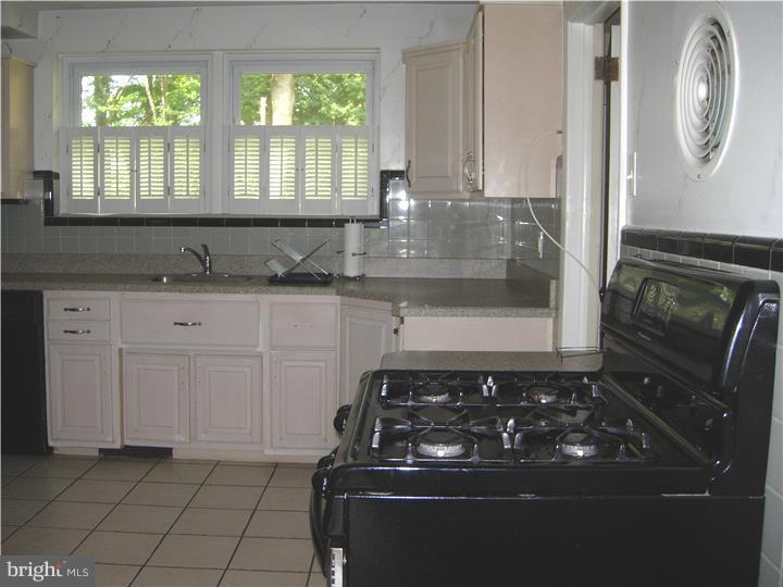 628 Mill Road Trevose, PA 19053 - Photo 10 of 18 a kitchen with granite countertop a stove a sink and a granite counter tops