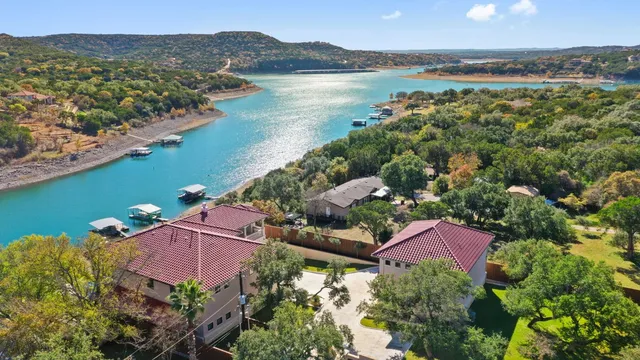 an aerial view of house with yard and ocean view
