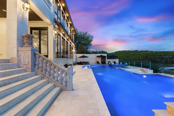 a view of a house with swimming pool and sitting area
