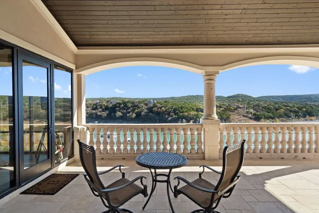 a view of a chairs and table in the balcony
