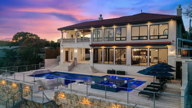 a front view of house with swimming pool and furniture
