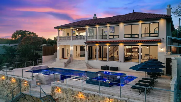 a front view of house with patio outdoor seating and city view