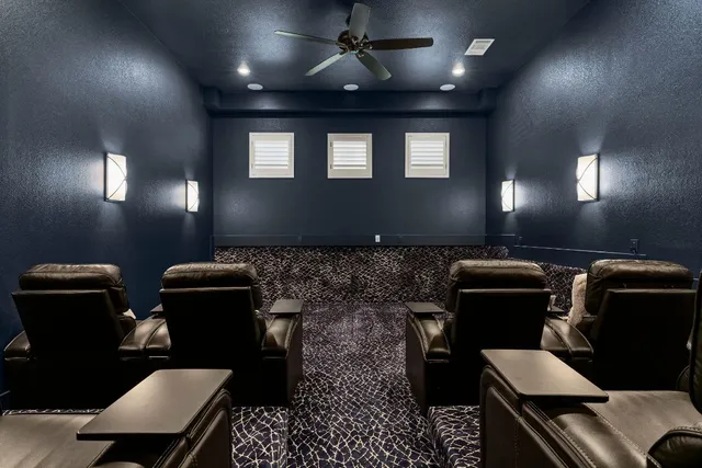 a media room with lots of chairs and a projector