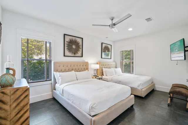 a bedroom with two beds and a large window