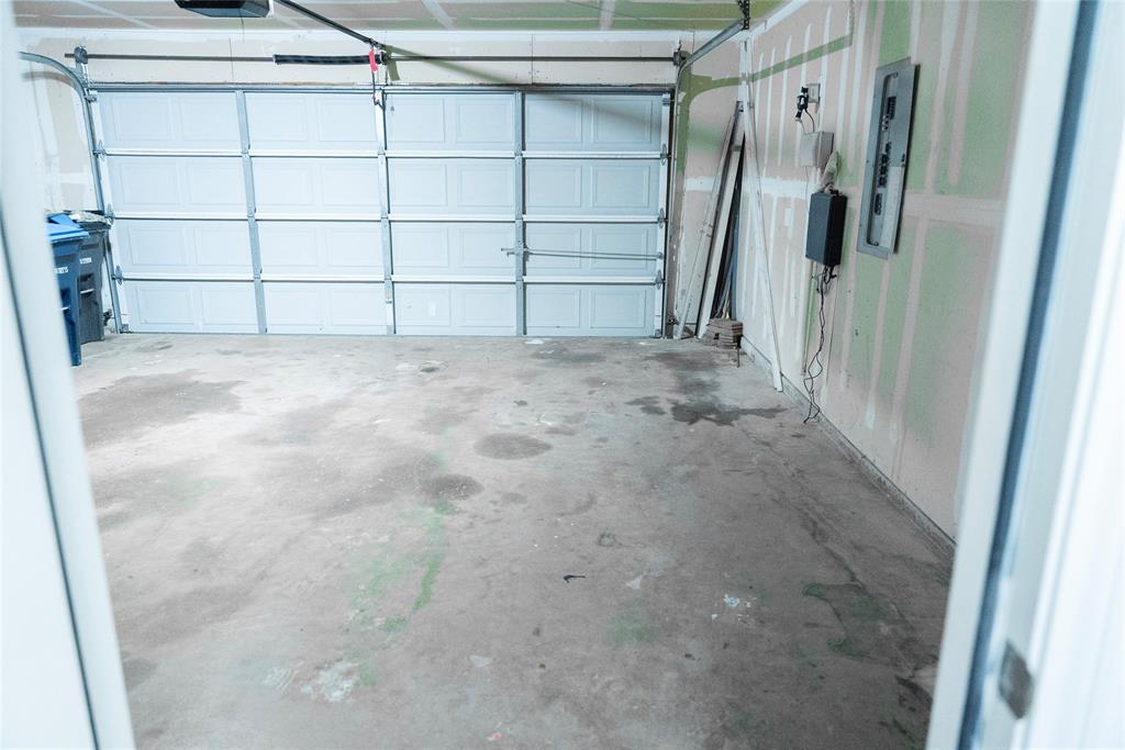 8805 Graywolf Ridge Trail Fort Worth, TX 76244 - Photo 23 of 23 Spacious garage with a concrete floor and a segmented overhead door