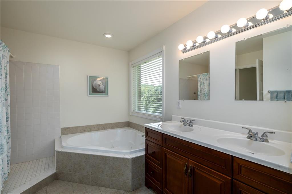 206 McCombs Road Venetia, PA 15367 - Photo 13 of 25 Master bath with cherry cabinets, dual sinks, corner jetted tub. tile shower, separate water closet, and dual master closets