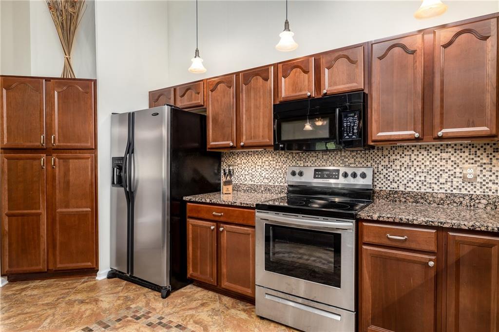 206 McCombs Road Venetia, PA 15367 - Photo 6 of 25 Cherry cabinets, ceramic floor, granite counters, glass tile backsplash, and stainless appliances