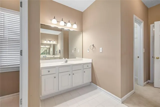 a spacious bathroom with a double vanity sink and a mirror