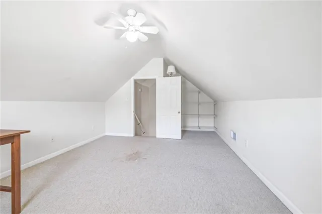 a view of a livingroom with a ceiling fan and window