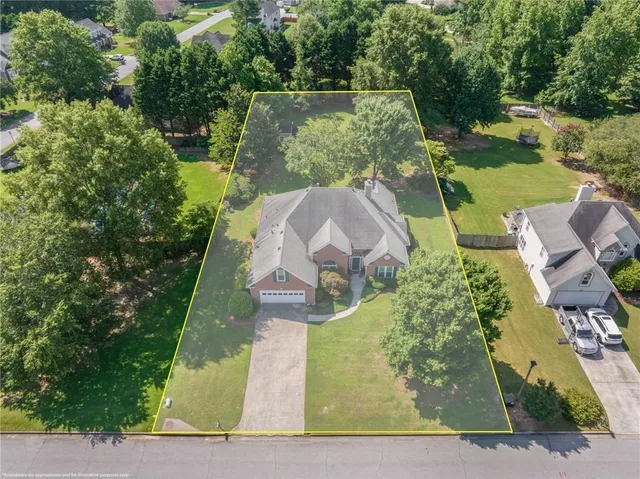 an aerial view of a house with outdoor space pool seating area and yard