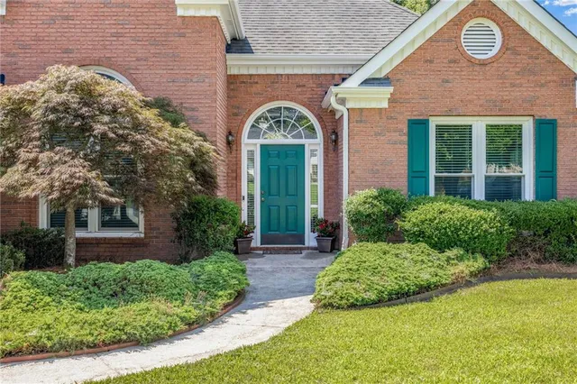 a front view of a house with garden