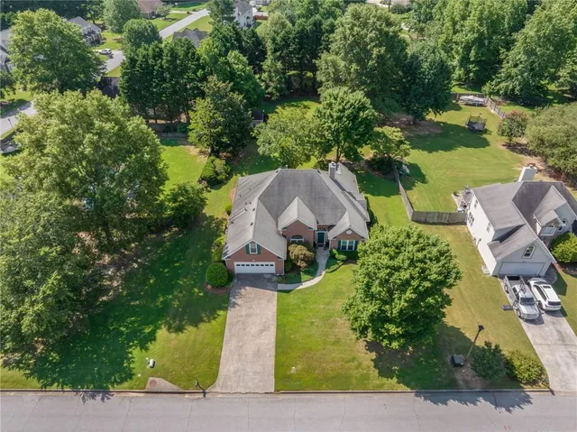 an aerial view of a house with garden space and street view