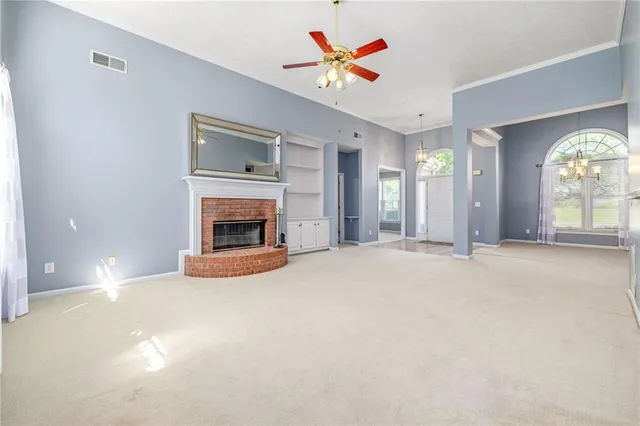 a view of an empty room with a fireplace