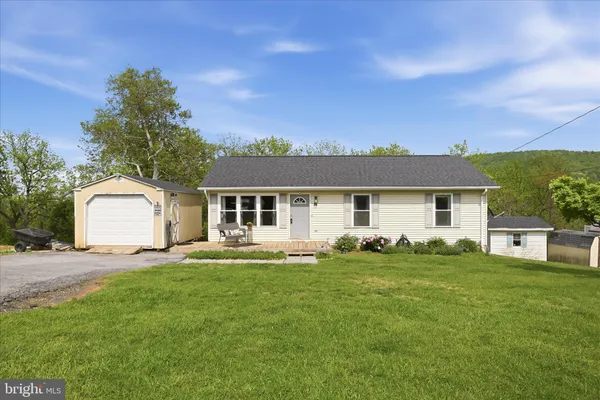 a front view of a house with a garden and yard