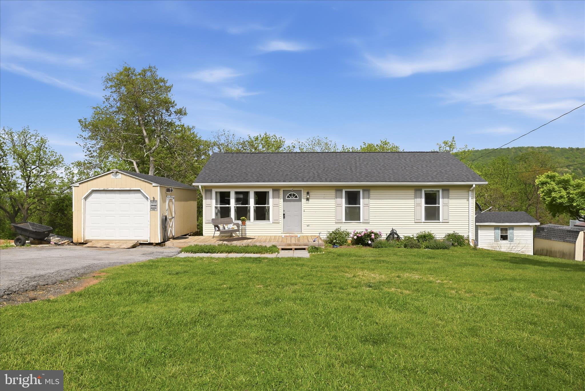 a front view of a house with a garden and yard