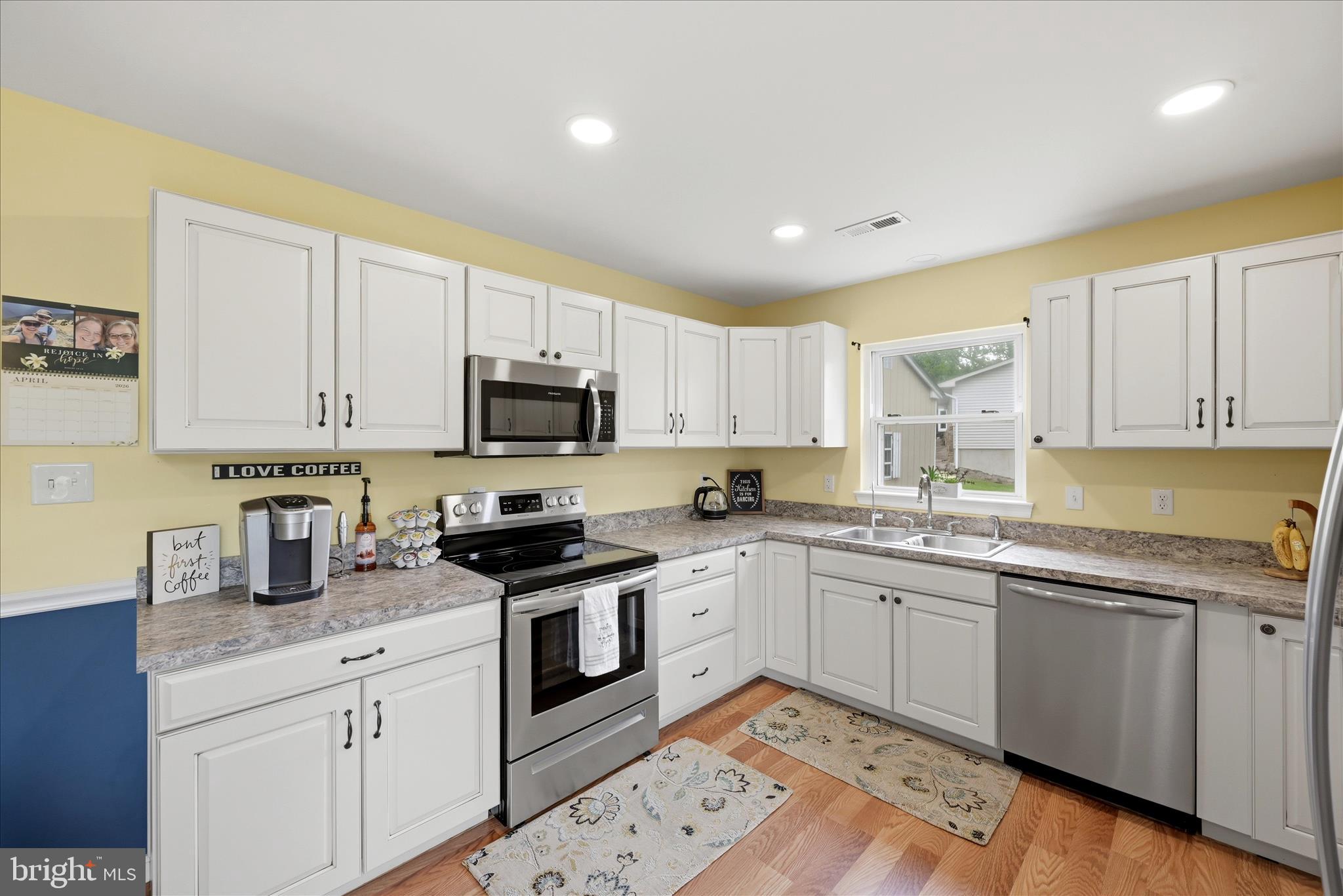 91 Granny Smith Road Linden, VA 22642 - Photo 18 of 65 a kitchen with granite countertop white cabinets sink and stainless steel appliances