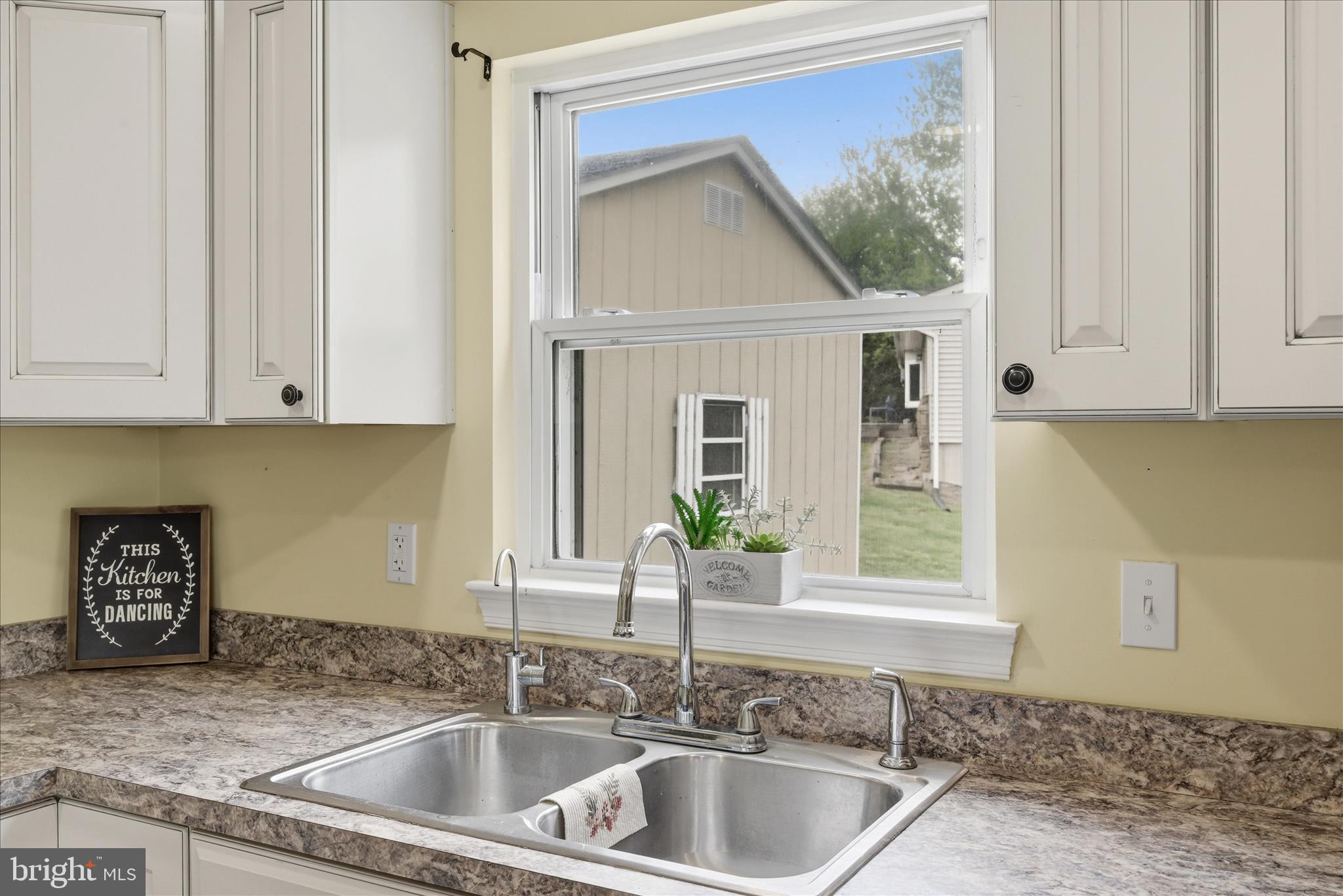 91 Granny Smith Road Linden, VA 22642 - Photo 19 of 65 a kitchen with granite countertop a sink and a window