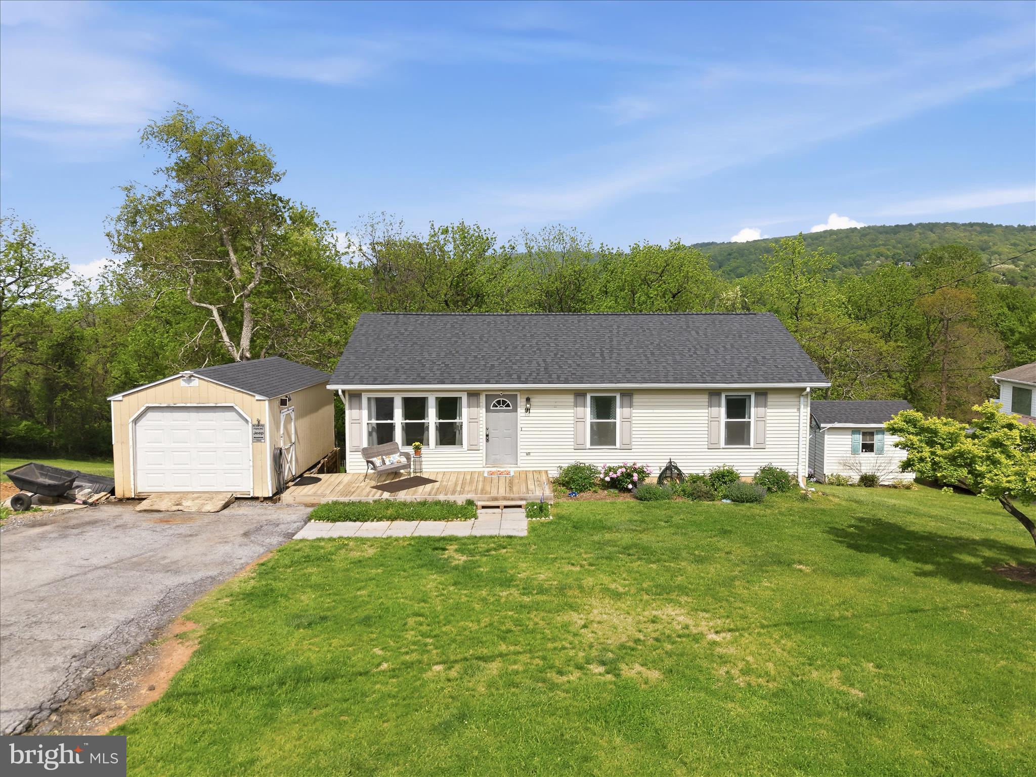 91 Granny Smith Road Linden, VA 22642 - Photo 57 of 65 a front view of a house with a garden and yard