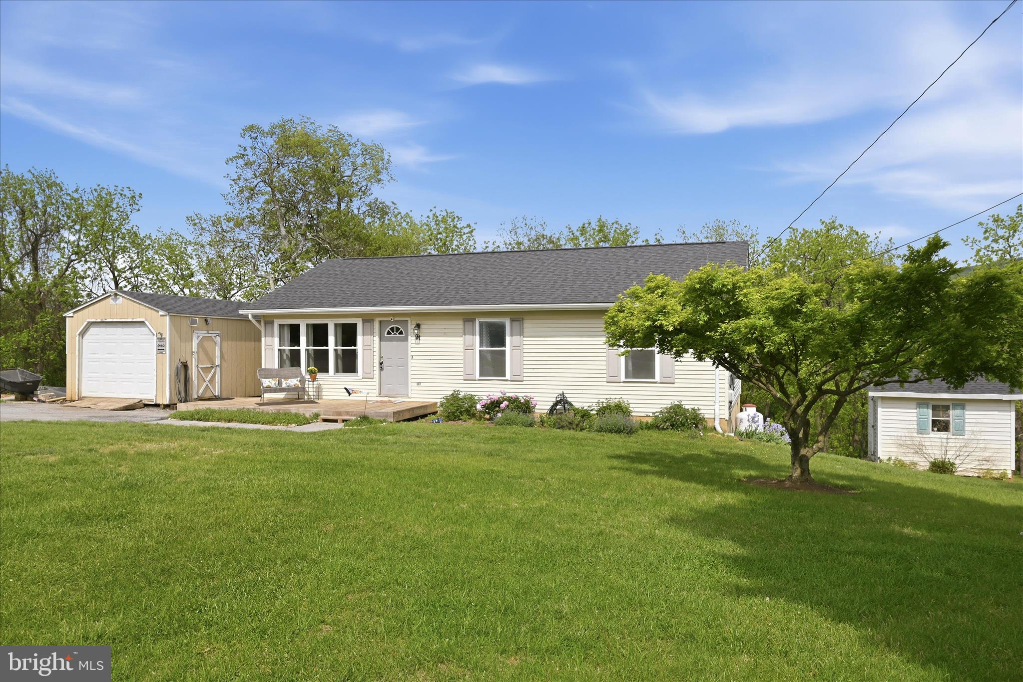 91 Granny Smith Road Linden, VA 22642 - Photo 59 of 65 a front view of a house with a garden and yard