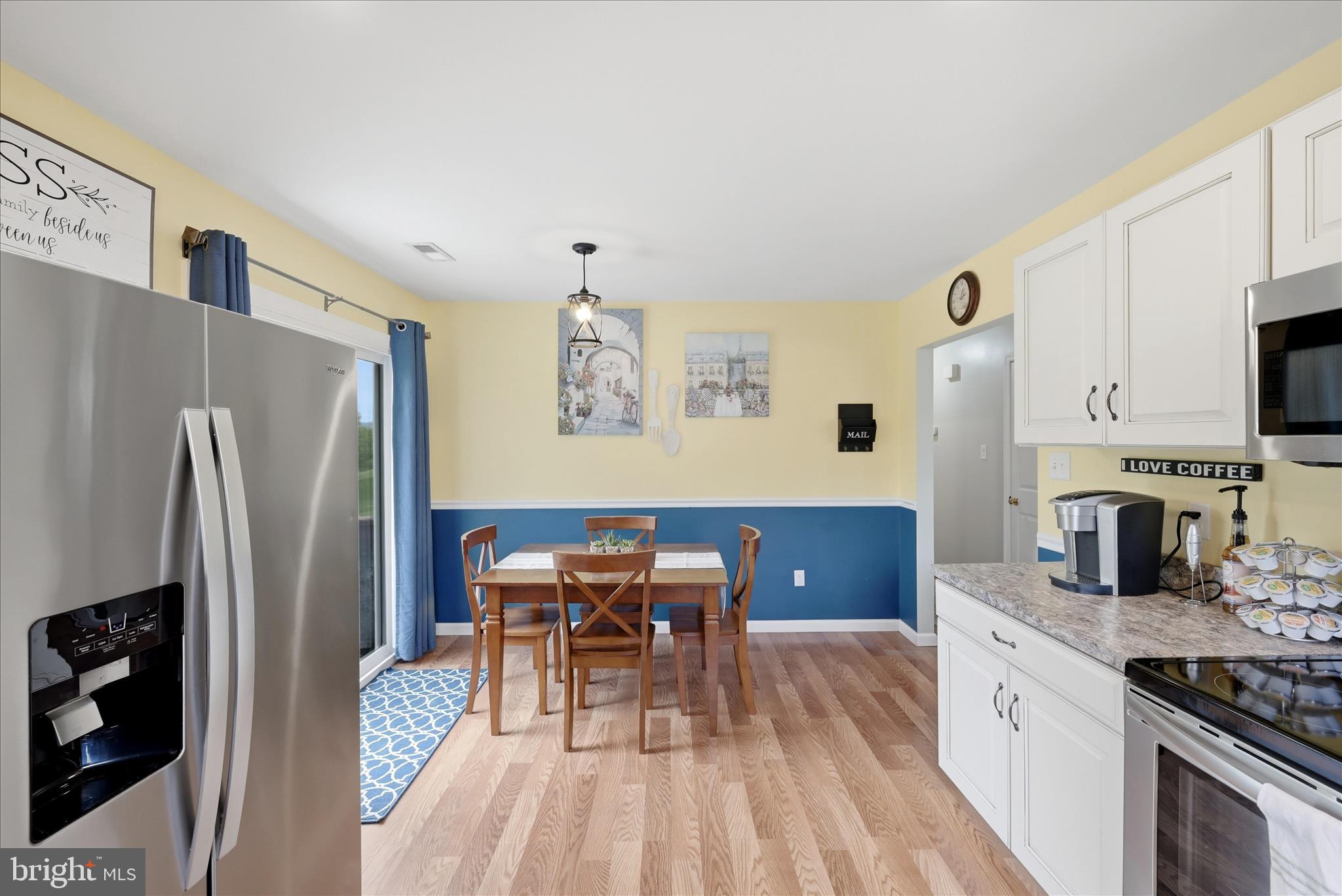 91 Granny Smith Road Linden, VA 22642 - Photo 7 of 65 a kitchen with stainless steel appliances granite countertop a refrigerator a stove top oven a sink dishwasher and dining table with wooden floor