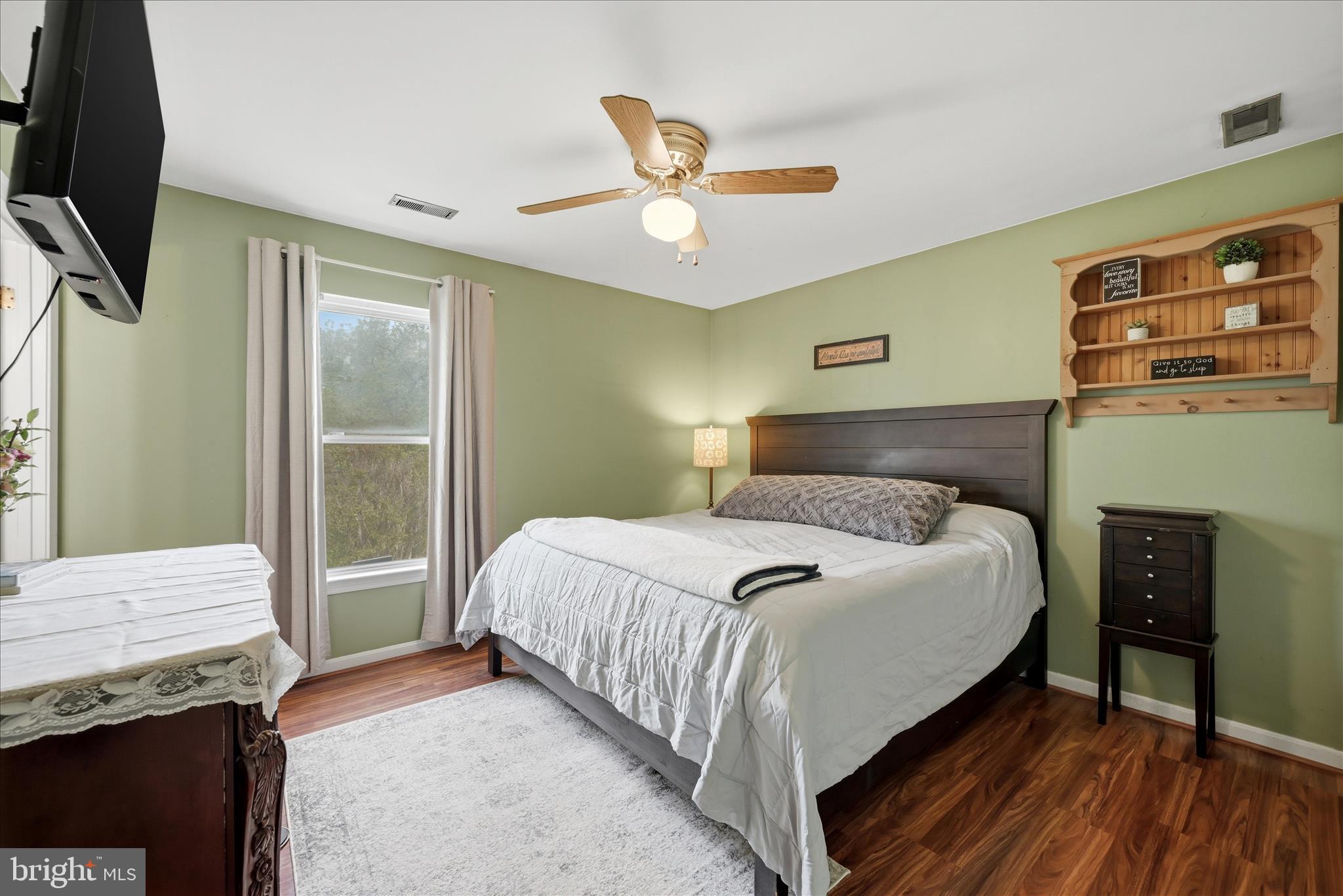 91 Granny Smith Road Linden, VA 22642 - Photo 9 of 65 a bedroom with a bed and a chandelier