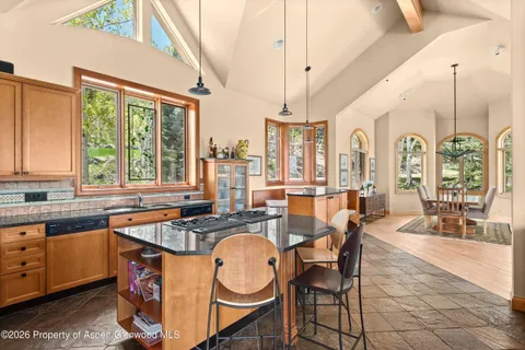 a dining room with furniture a chandelier and wooden floor