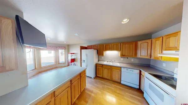 a kitchen with stainless steel appliances granite countertop a sink and stove
