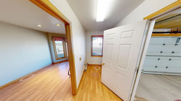 a view of a hallway with wooden floor