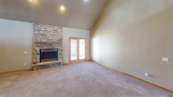 an empty room with a fireplace and window