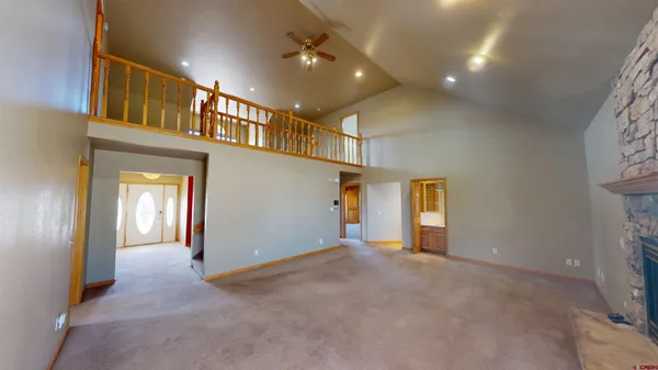 a view of a hallway with wooden floor and entryway