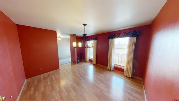 a view of a room with wooden floor and window