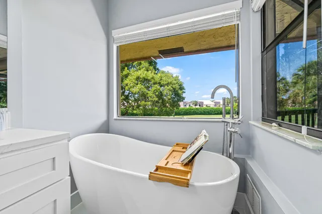 a bedroom with a bed a dresser and mirror