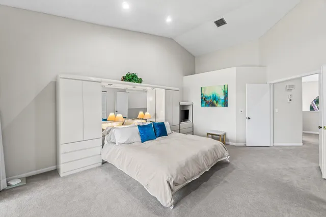 a view of a house with a yard and potted plants