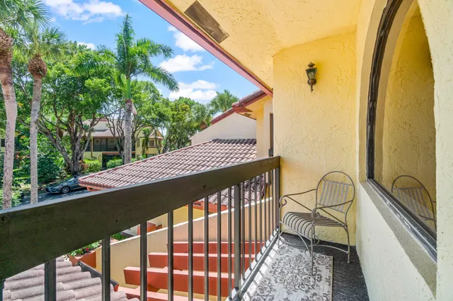 a view of a swimming pool with outdoor seating and a garden