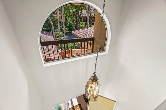 an aerial view of a house with swimming pool and lake view