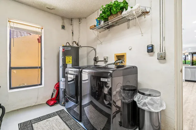 a dining room with furniture and a floor to ceiling window
