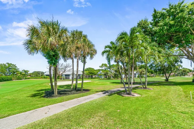 an aerial view of residential houses with outdoor space and swimming pool