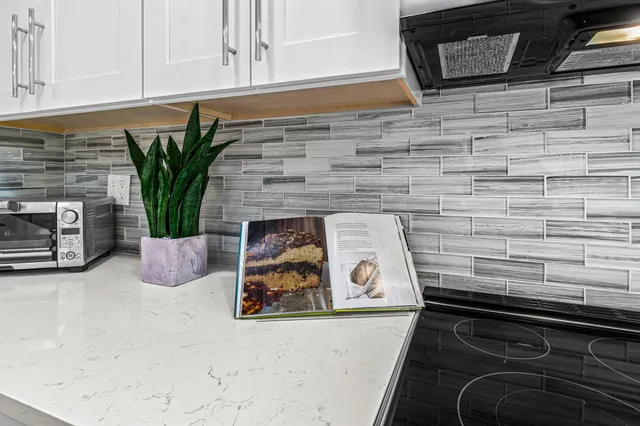 a view of a balcony with chair and potted plants