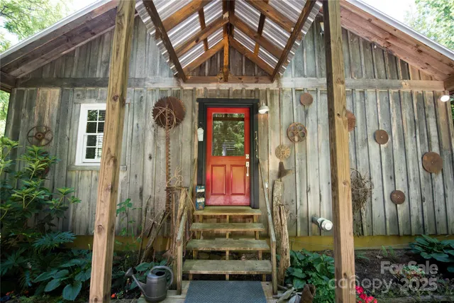 a front view of a house with a yard and potted plants
